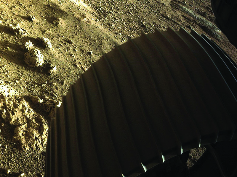 An image from Perseverance rover of the surface of Mars and one of the rover's wheels after landing. <br>