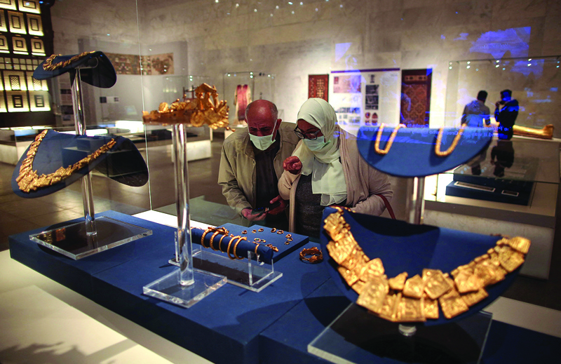 Visitors look at displayed ancient jewelry at Egypt's new National Museum of Egyptian Civilization (NMEC).<br>
