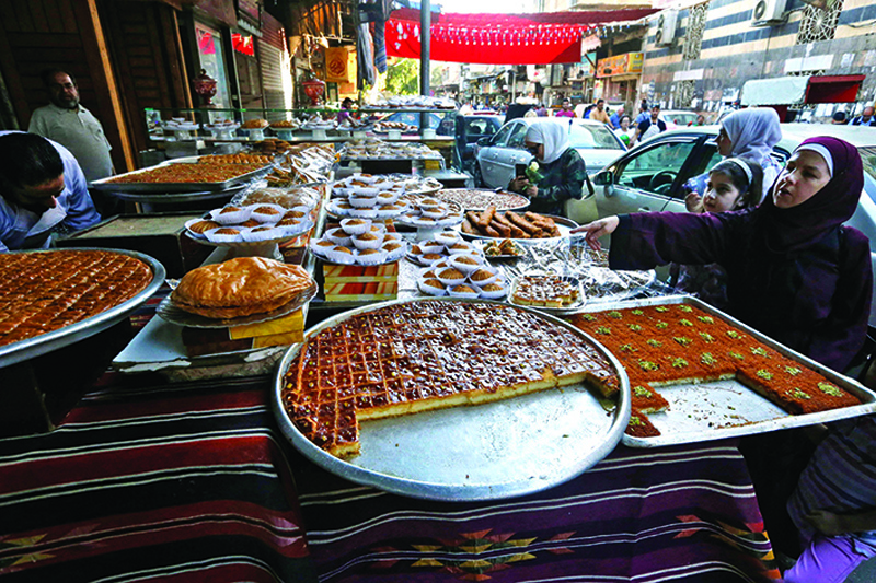 Syrians buy traditional sweets in Damascus' Midan neighborhood during the Muslim holy month of Ramadan.