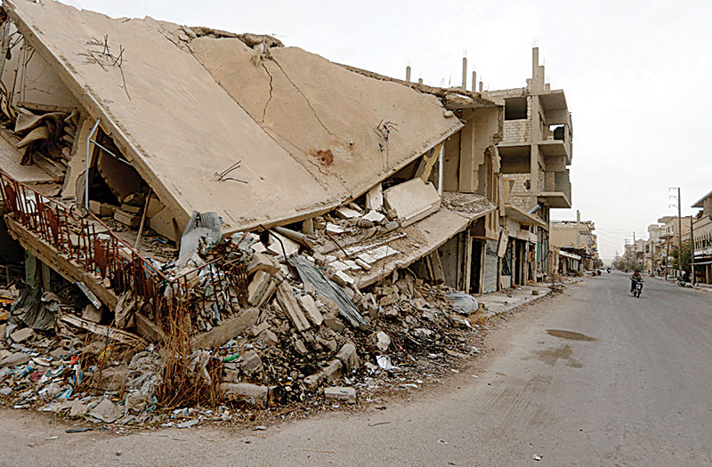 Picture shows the damage in a street in the central Syrian town of Al-Qaryatain in the Homs province.