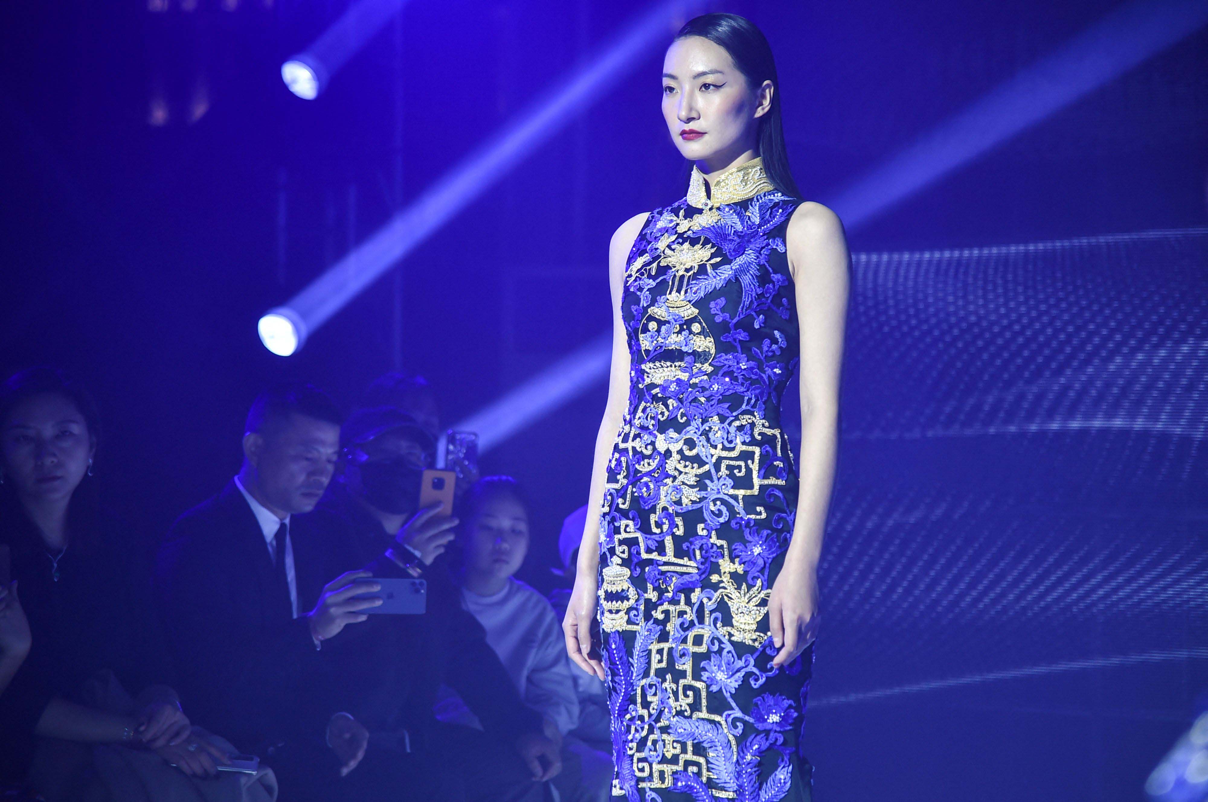 A model wearing traditional Chinese dress Qipao rehearsing for a Shanghai fashion show.<br>