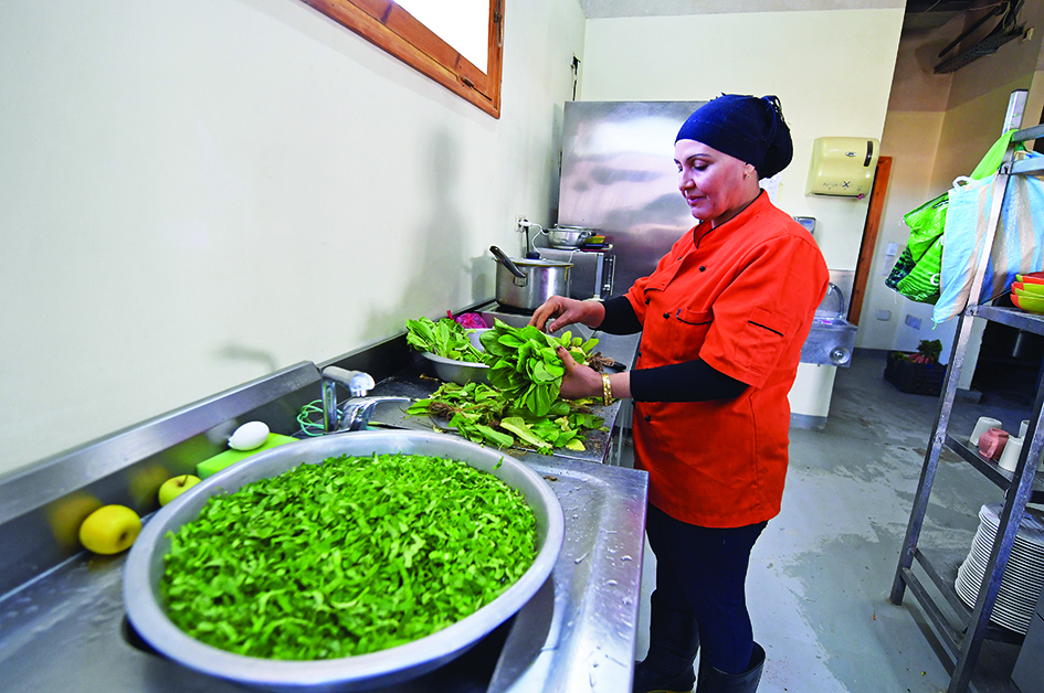 Chef Najah Ameur prepares a salad from vegetables grown in their premises at Dar Hi hotel's in the remote Nefta oasis.<br>