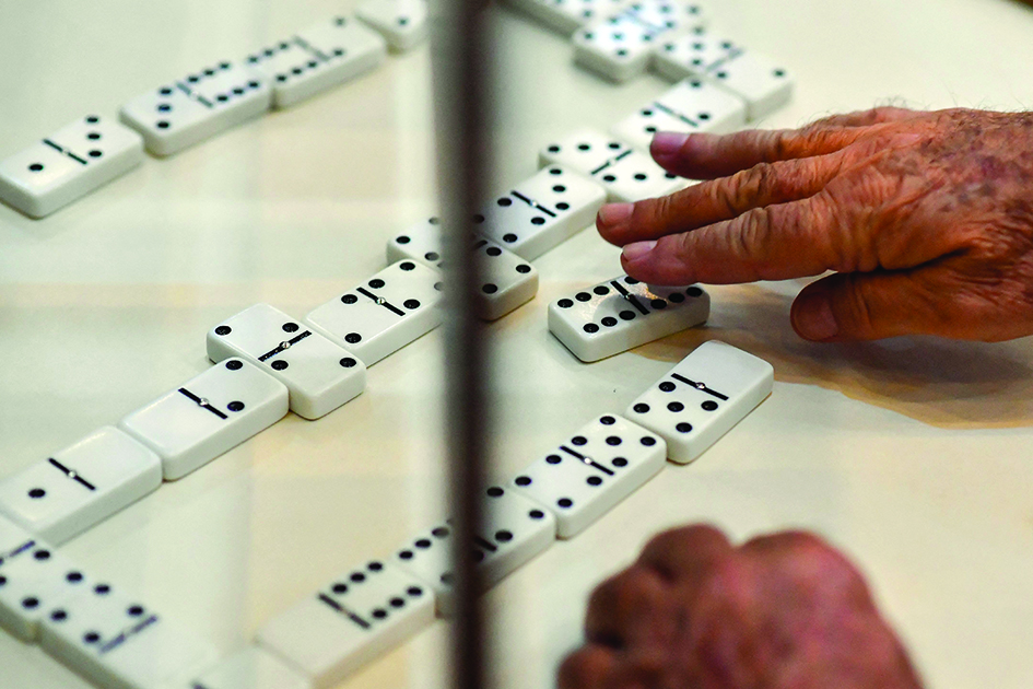 A man takes part in a domino match during a National domino tournament in Valencia.<br>