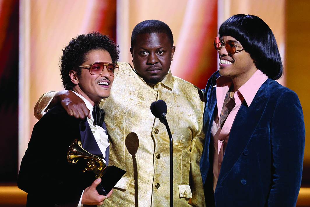 (From left) Bruno Mars, Dernst Emile II, and Anderson .Paak of Silk Sonic accept Song Of The Year for ‘Leave The Door Open’ onstage.