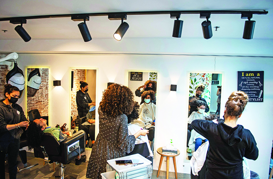 Sara Safwat (center), hairstylist and founder of the
