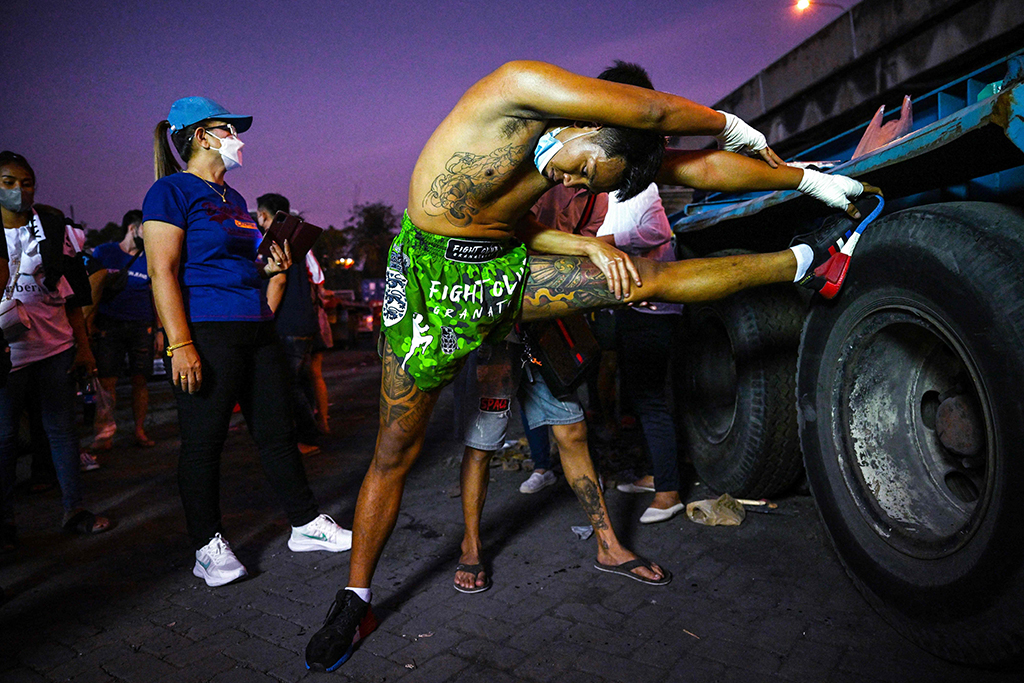 This photo shows a fighter warming up at an event by Fight Club Thailand.