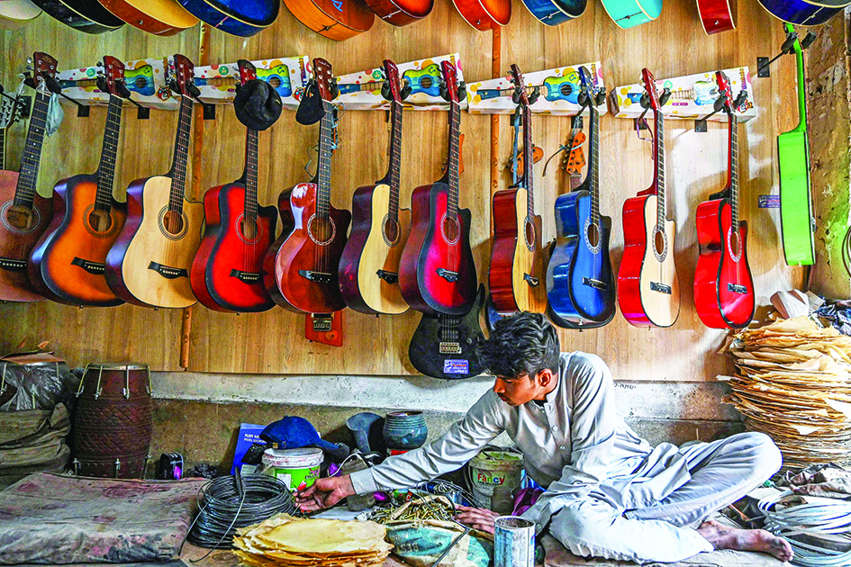 A shopkeeper works at a musical instruments.