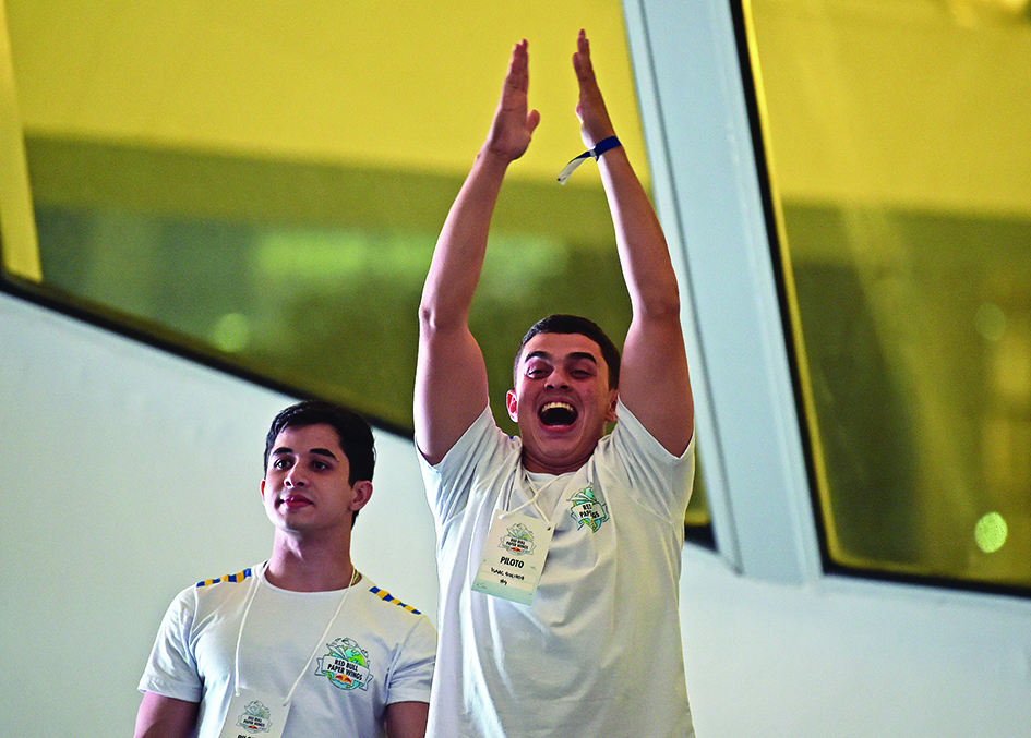 Competitor Isaac Queiroz Leite celebrates after throwing his paper plane a winning distance of 40.3 meters. 