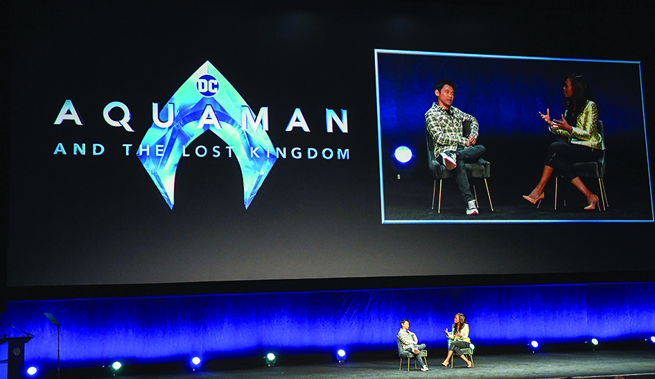 Australian Producer/Director James Wan and US actress Aisha Tyler (right) speak onstage during the Warner Bros Pictures 