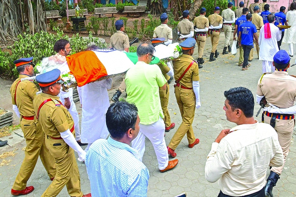 Policemen and family members take part in the funeral ceremony of legendary Indian composer and santoor player Shivkumar Sharma.