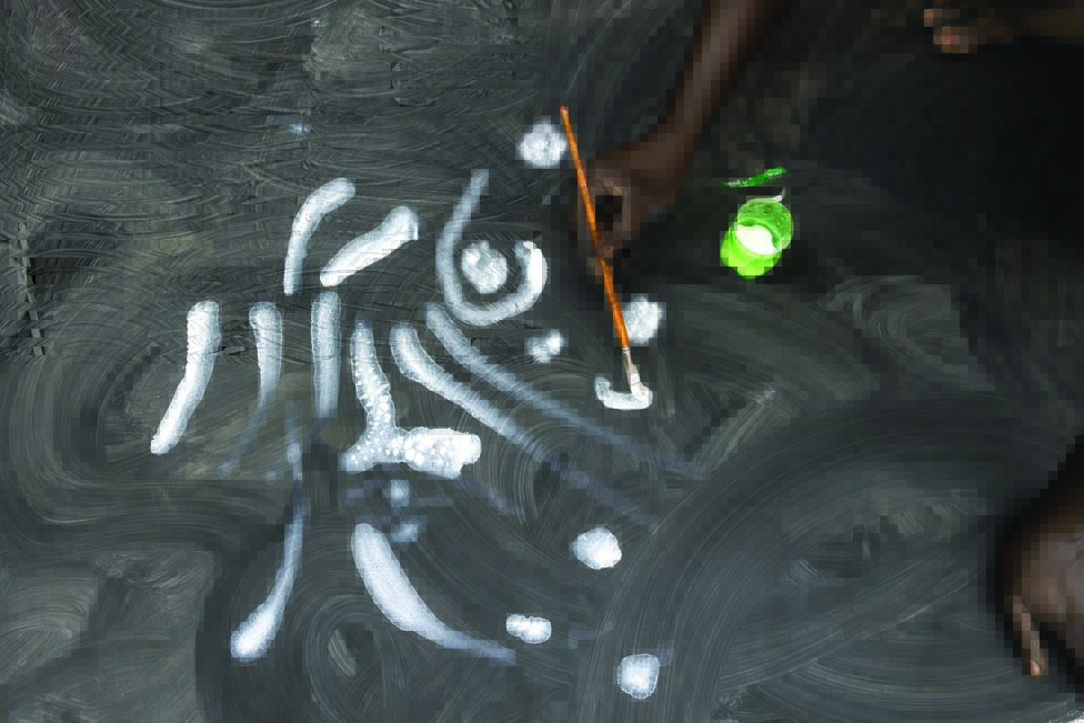 Contemporary Senegalese artist, Omar Ba, paints onto a black canvas at his workshop.