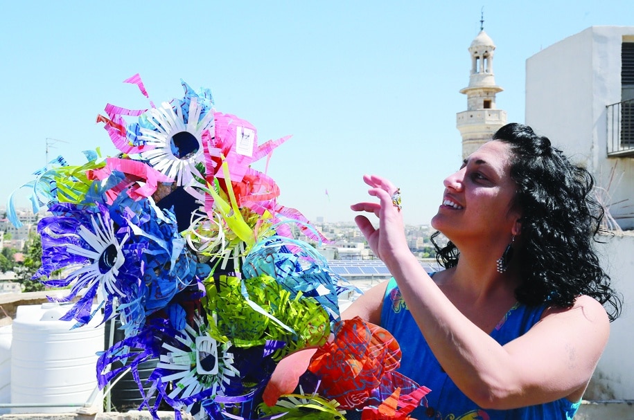 Maria Nissan shows one of her art pieces created from plastic waste collected from the streets.