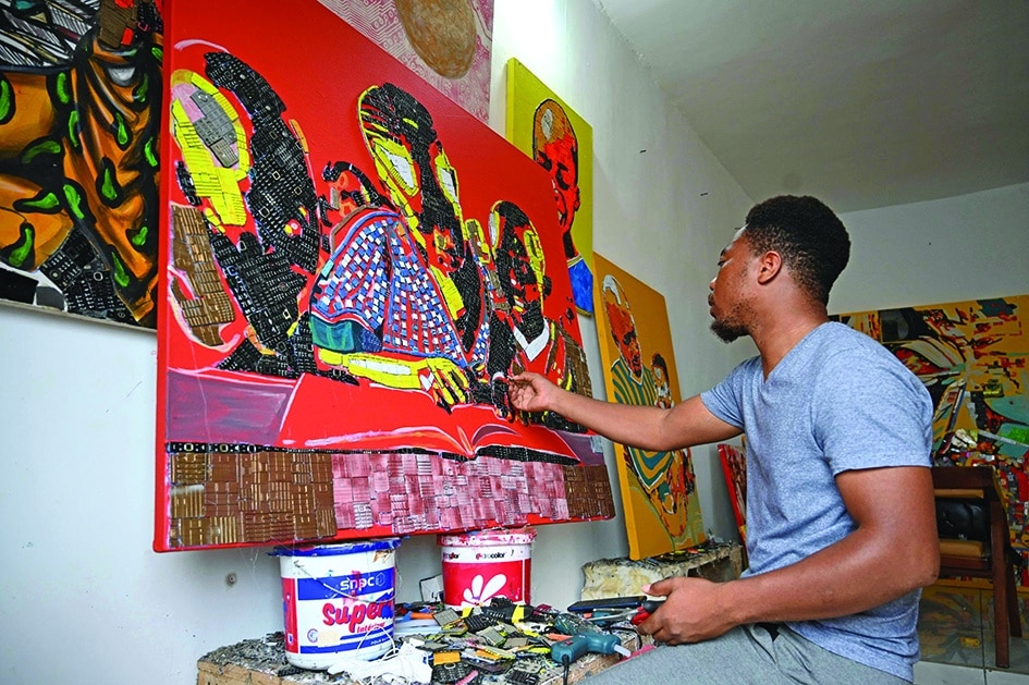 Ivorian artist Mounou Dersire Koffi makes an artwork with used telephone keyboards.