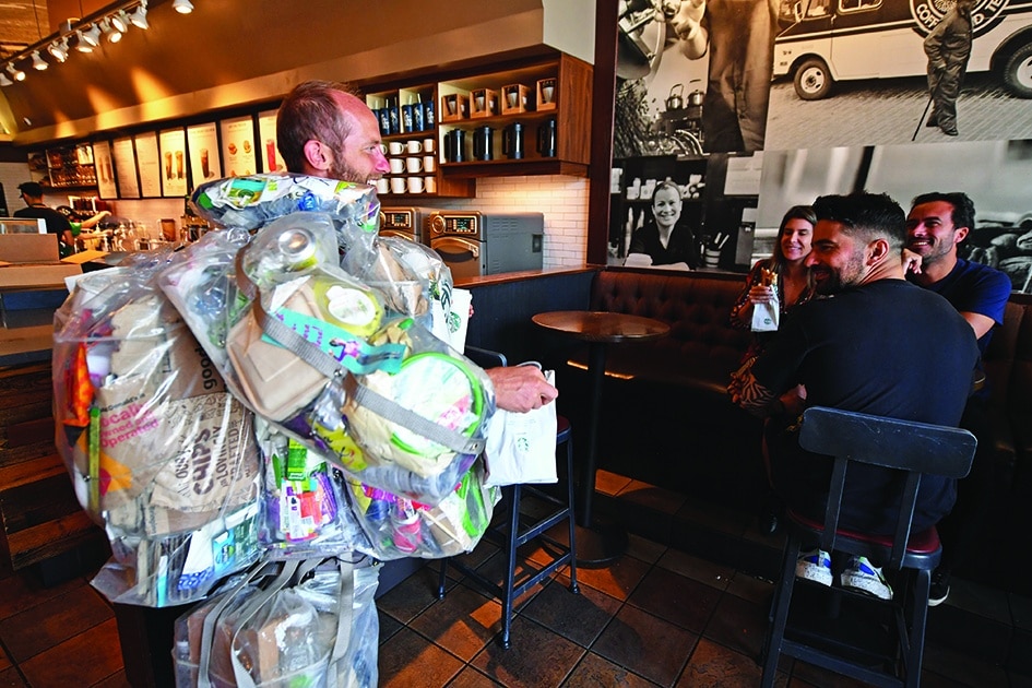 Environmental activist Rob Greenfield talks to customers in a Starbucks in Beverly Hills.