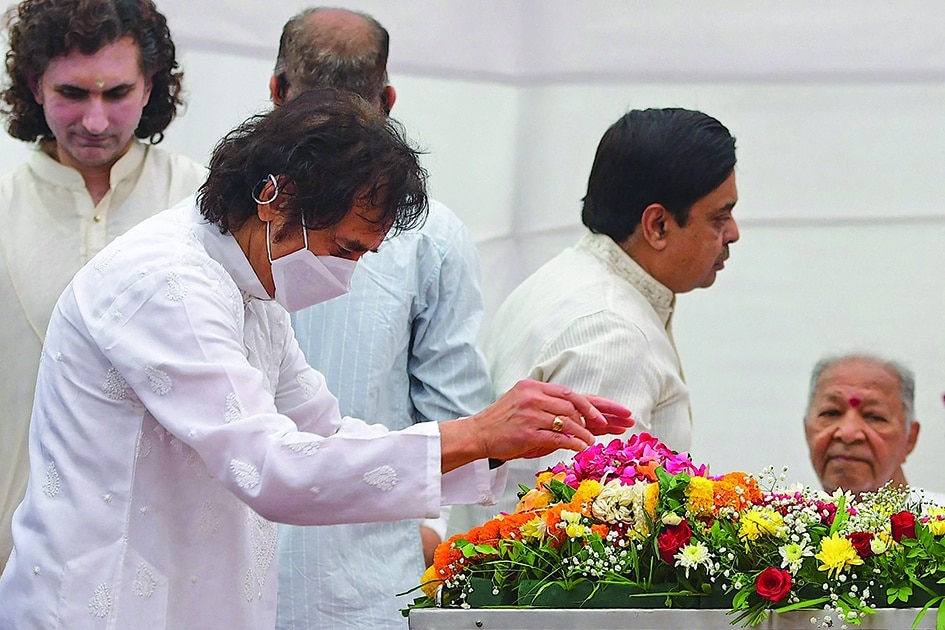 India's tabla player Zakir Hussain pays respect during the funeral.