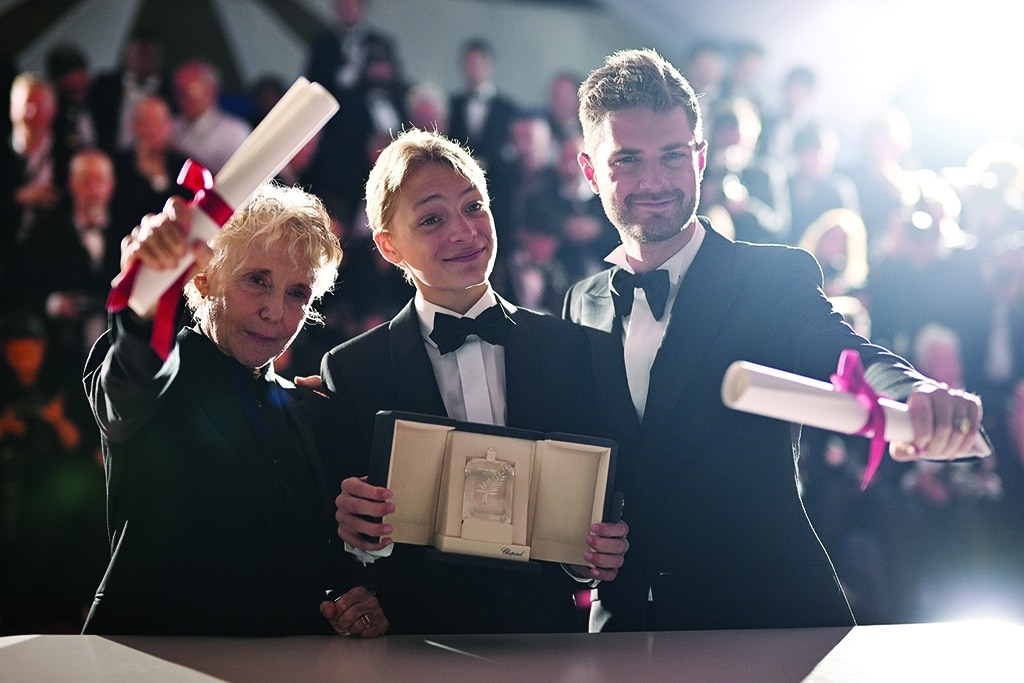 (From right) Belgian director Lukas Dhont, Belgian actor Eden Dambrine pose with his trophy during a photocall after he won equally the Grand Prix for the film
