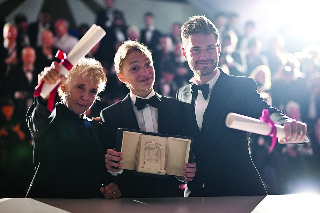 (From right) Belgian director Lukas Dhont, Belgian actor Eden Dambrine pose with his trophy during a photocall after he won equally the Grand Prix for the film 