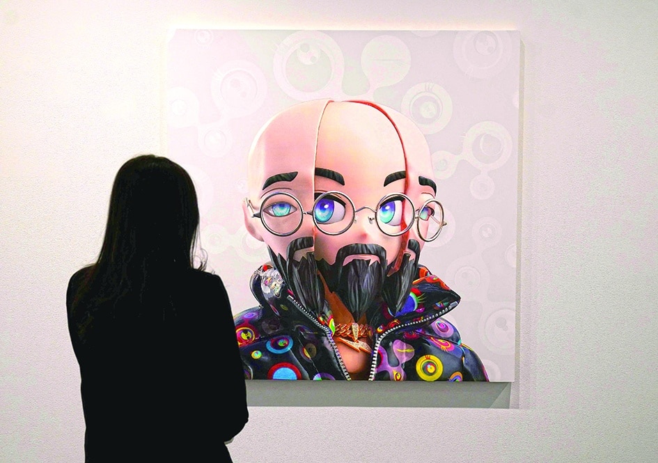 A person stands in front of artist Takashi Murakami’s “#1 Murakami Arhat, 2022”.