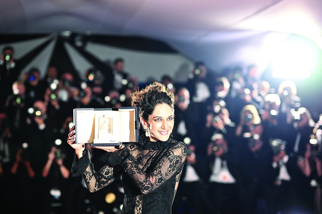 Iranian actress Zar Amir-Ebrahimi poses with her trophy during a photocall after she won the Best Actress Prize for her part in