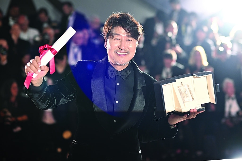South Korean actor Song Kang-Ho poses with his trophy during a photocall after he won the Best Actor Prize for his part in