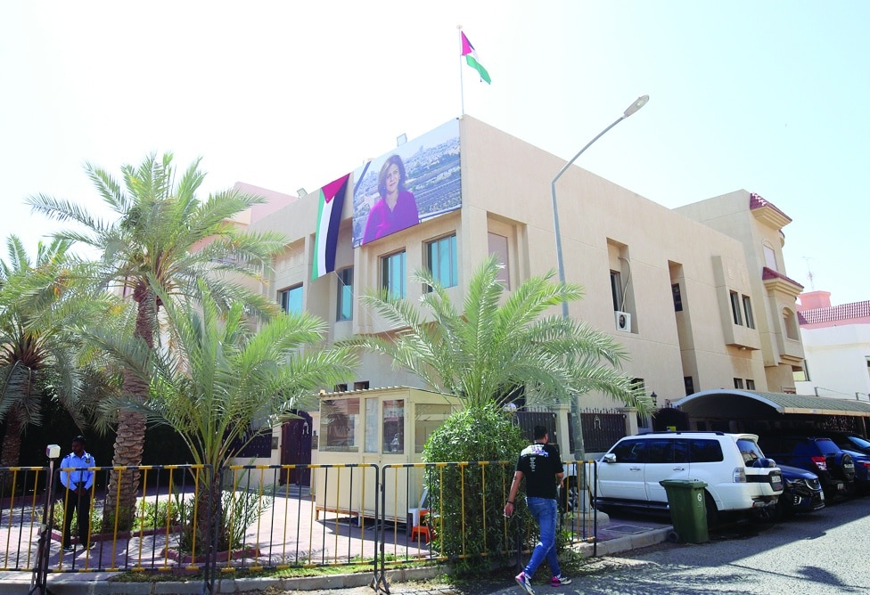 A large portrait of fallen journalist Shireen Abu Akleh and a Palestinian flag are draped over the Embassy of Palestine's building.