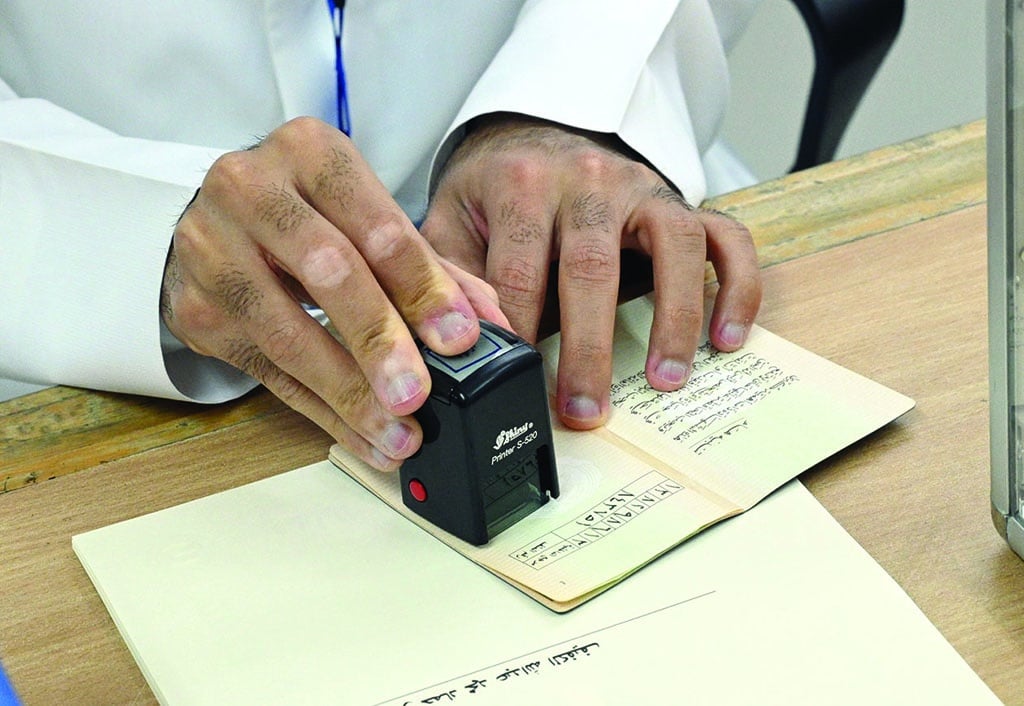 A passport is stamped at a polling station.