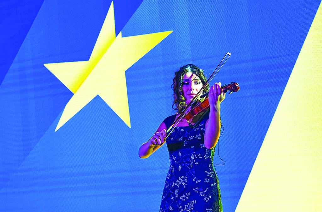 A performer plays the violin during the event.<br>