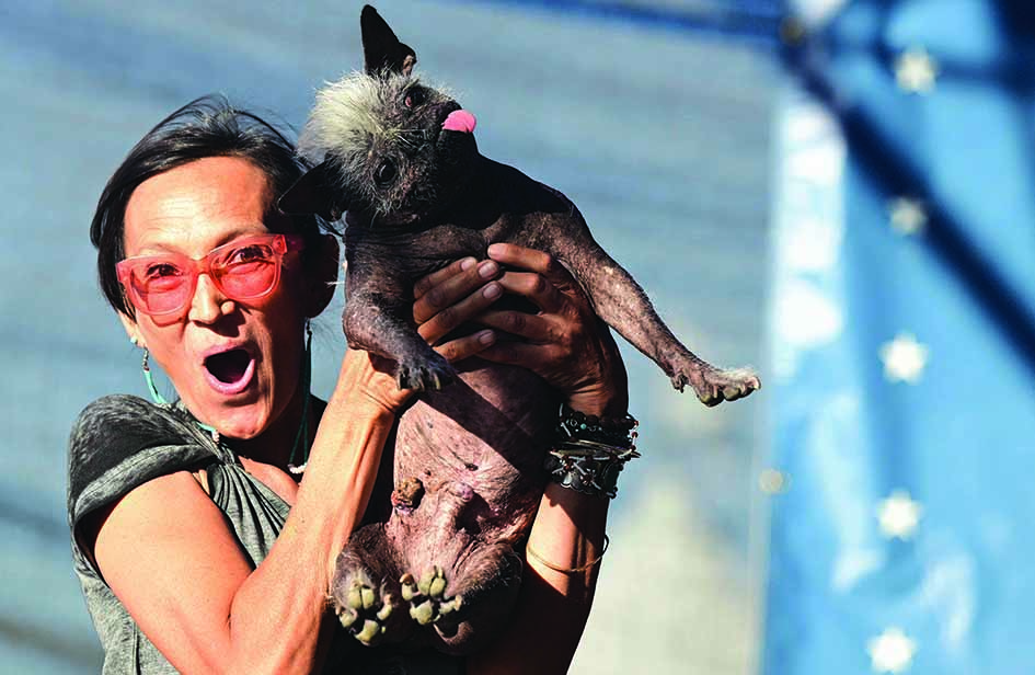 Jeneda Benally reacts to the announcement that her dog Mr Happy Face won the World's Ugliest Dog Contest in Petaluma.