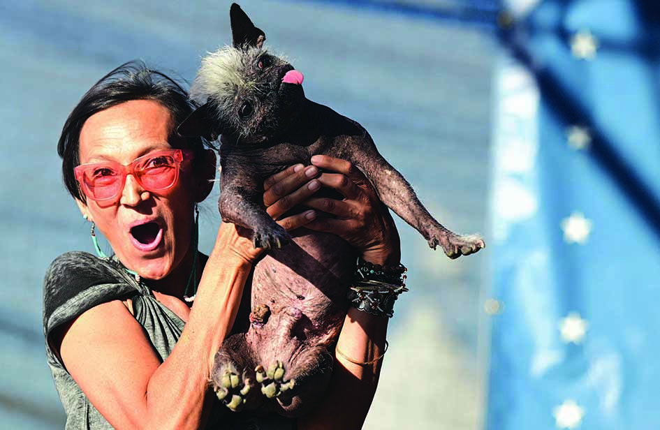 Jeneda Benally reacts to the announcement that her dog Mr Happy Face won the World's Ugliest Dog Contest in Petaluma.