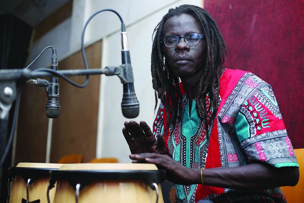 A musician plays the conga during rehearsals at a studio in Omdurman, the capital Khartoum's twin city.