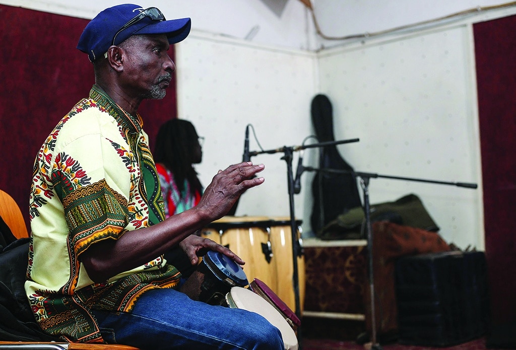 A musician plays the bongos during rehearsals at a studio in Omdurman.