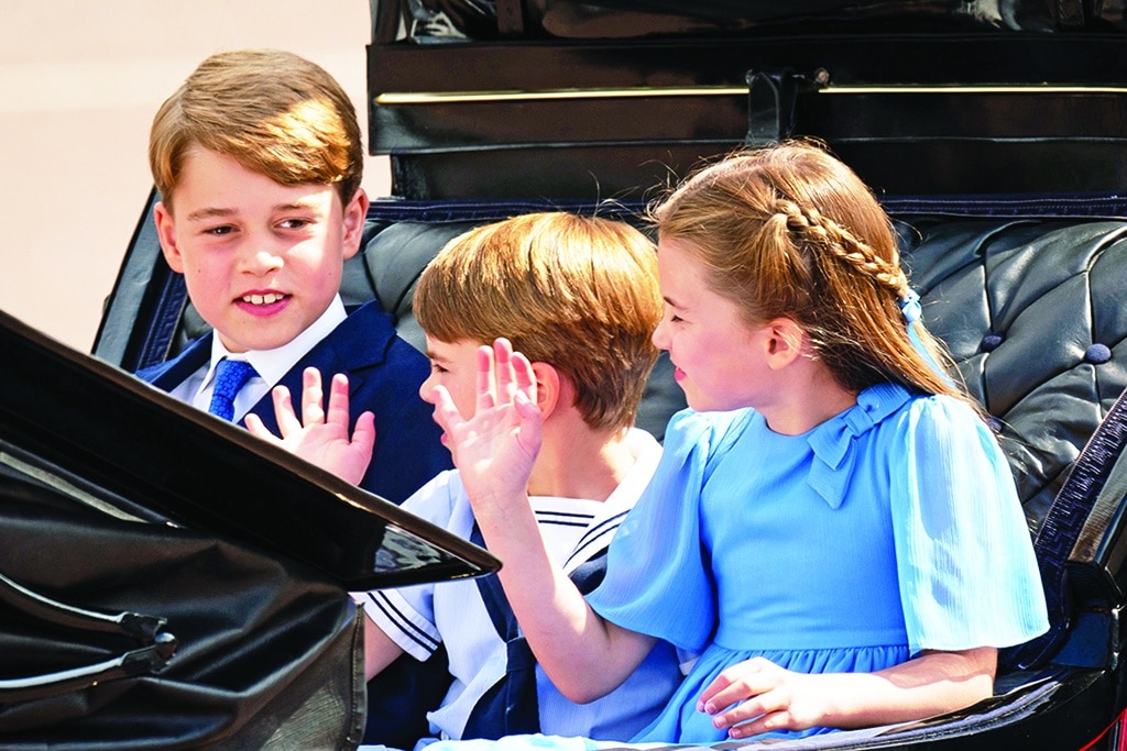 Britain's Prince George of Cambridge (left), Britain's Prince Louis of Cambridge (center) and Britain's Princess Charlotte of Cambridge travel in a horse-drawn carriage during the Queen's Birthday Parade, the Trooping the Color, as part of Queen Elizabeth II's platinum jubilee celebrations.