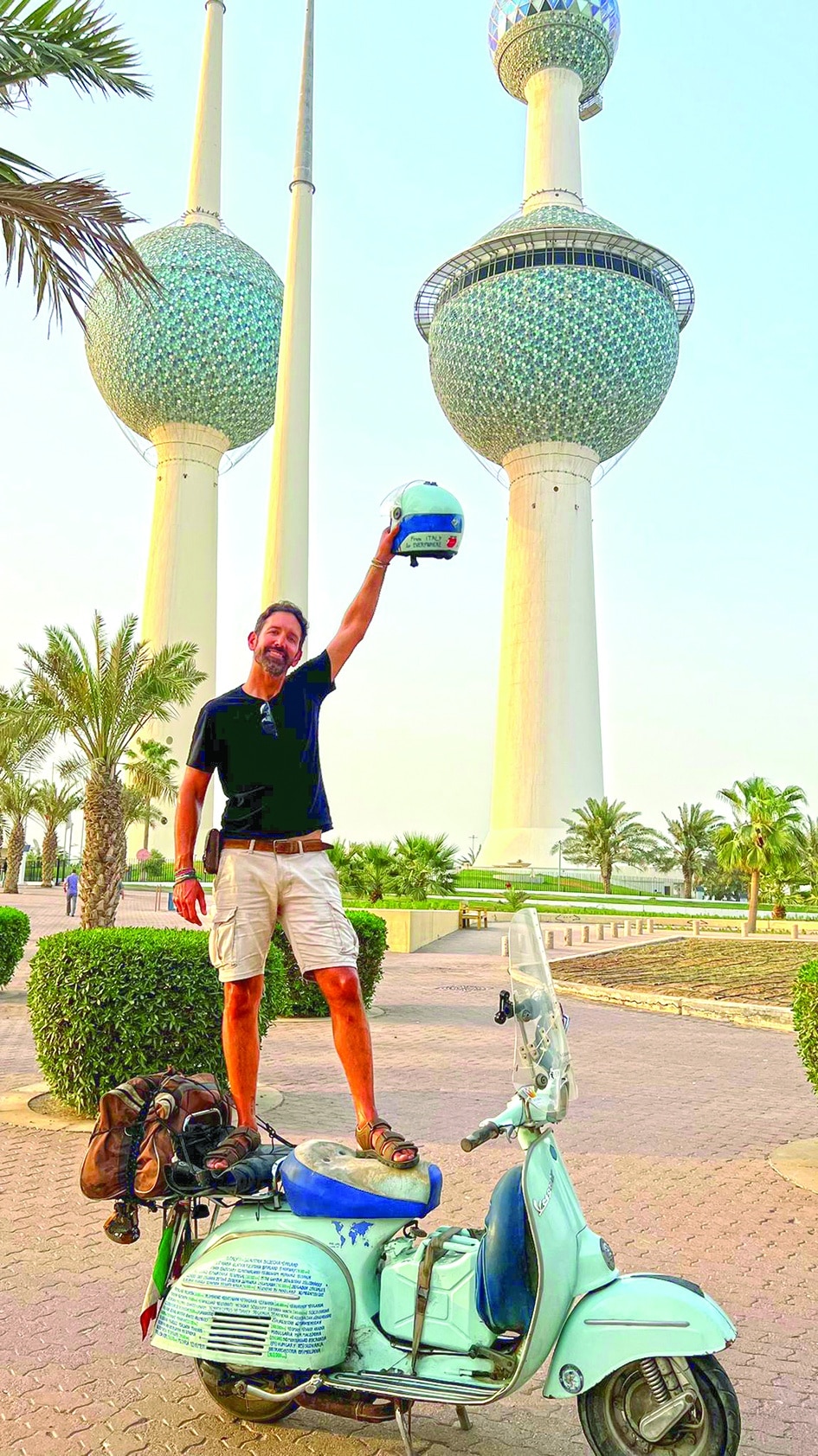 Ilario Lavarra poses in front of Kuwait Towers.