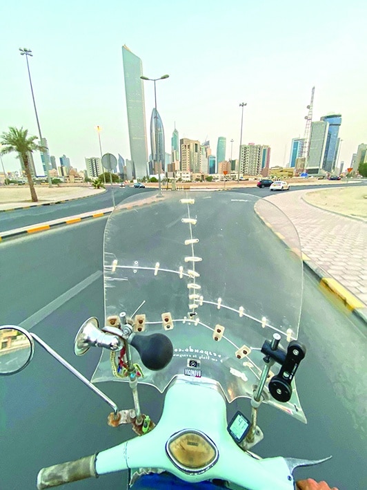 Ilario Lavarra drives on a road during his stop in Kuwait.