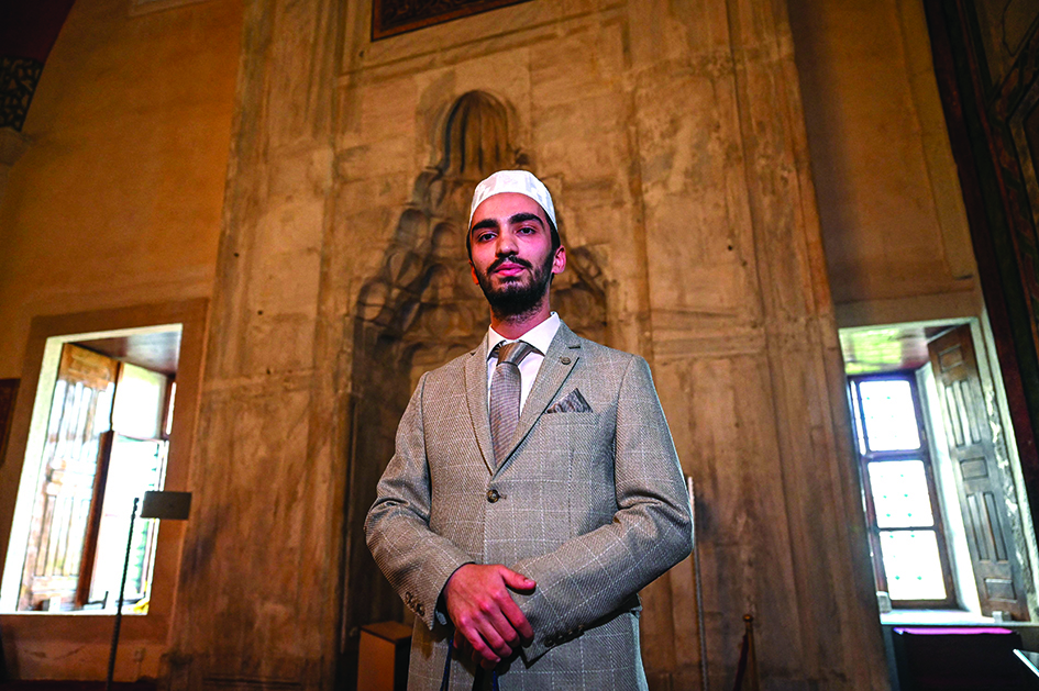 Turkish muezzin Abdullah Omer Erdogan, winner of the Ezan call to prayer contest, poses inside Old mosque (Eski Camii).