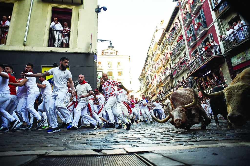 Participants run ahead of bulls.