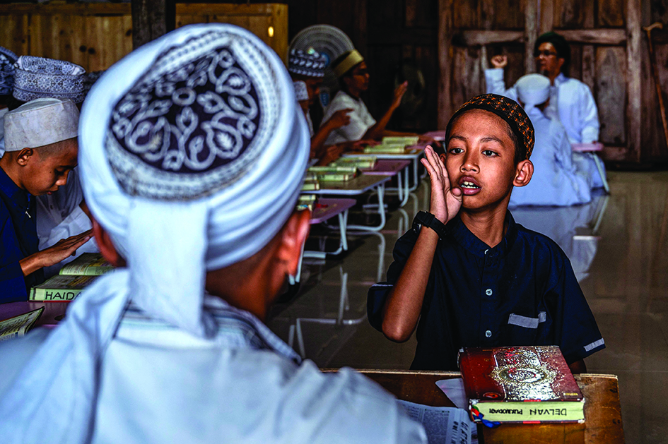 A student recites the Quran using sign language at an Islamic boarding school for deaf children in Sleman.