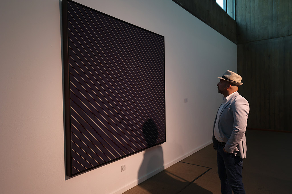 A visitor looks at an installation by American painter Frank Stella.