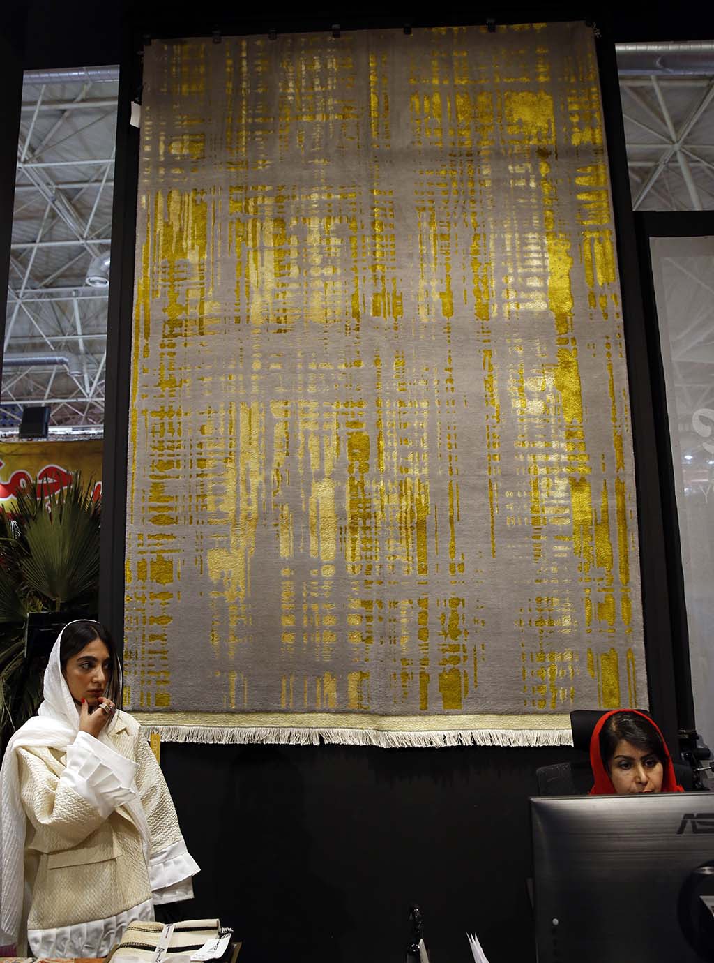 An Isfahan gray wool carpet with yellow and green silk motifs is displayed at the 29th Handmade Carpet Exhibition.