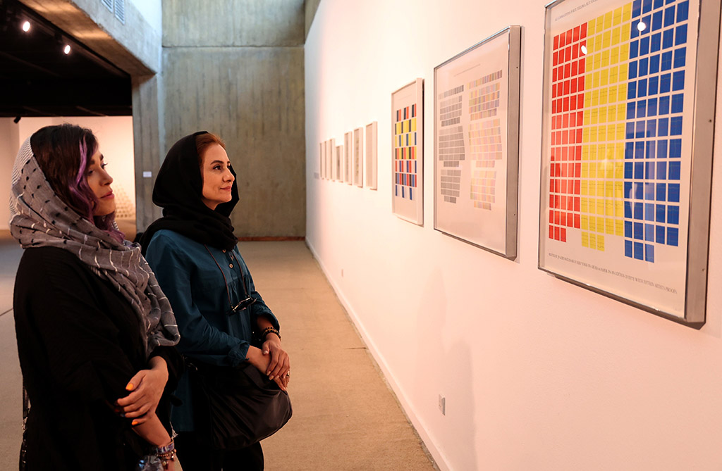 Visitors look at artwork by American artist Sol LeWitt.