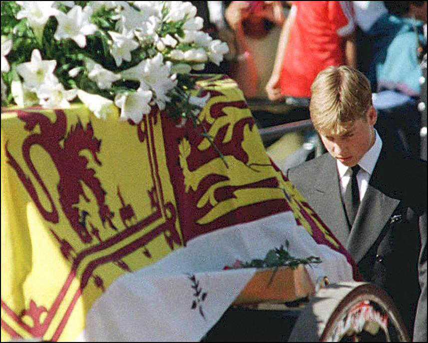 In this file photo taken on September 6, 1997 Prince William walks with his head bowed behind the coffin of his mother Diana, Princess of Wales draped in the Royal Standard, on its way to London's Westminster Abbey for the funeral ceremony.