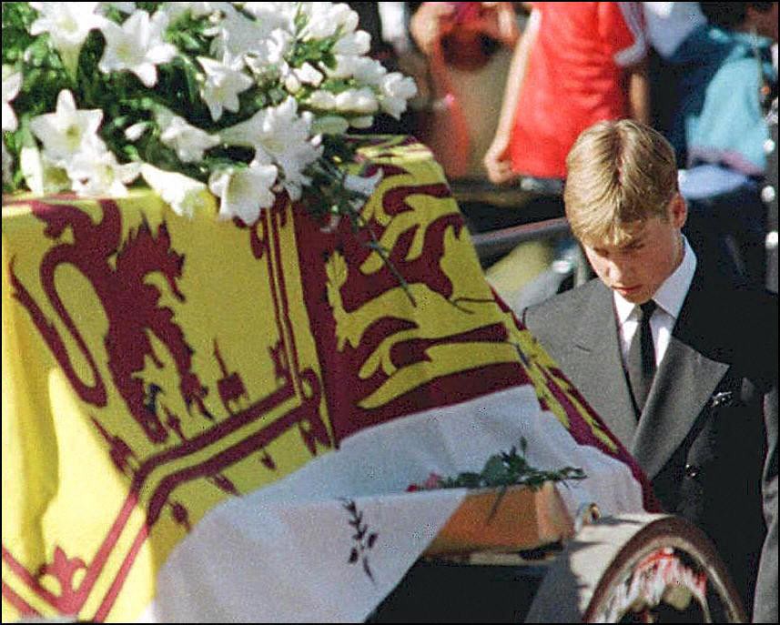 In this file photo taken on September 6, 1997 Prince William walks with his head bowed behind the coffin of his mother Diana, Princess of Wales draped in the Royal Standard, on its way to London's Westminster Abbey for the funeral ceremony.
