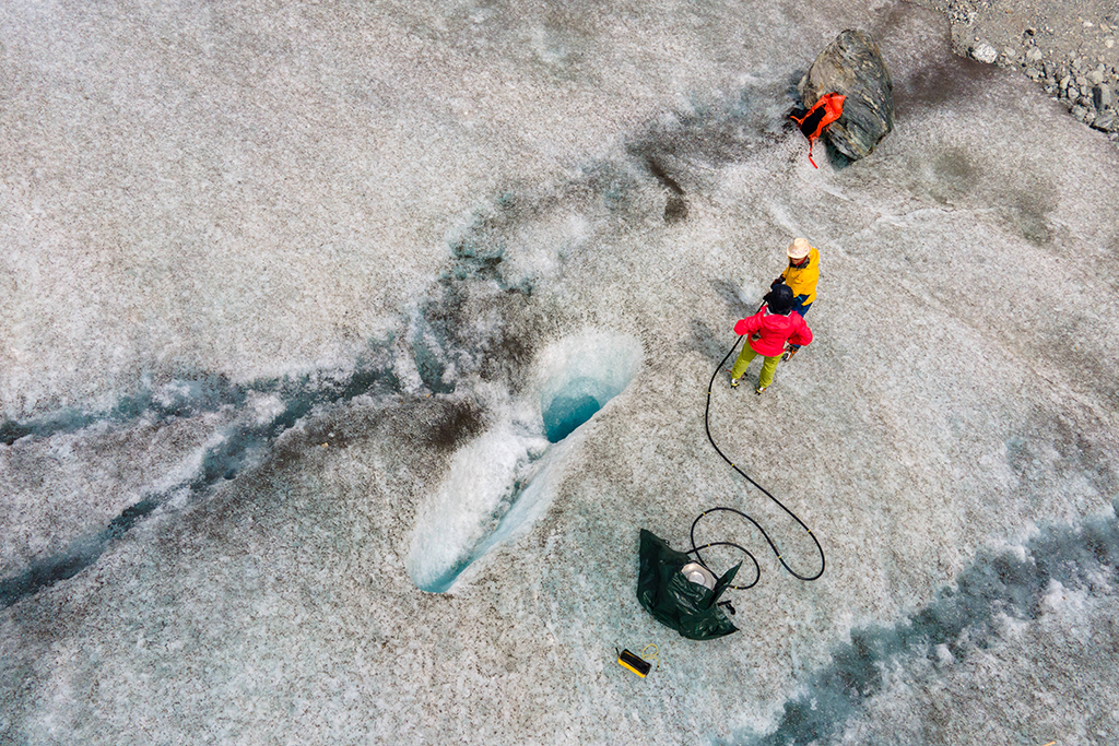 An aerial view shows glaciologists Andrea Fischer (yellow) and Violeta Lauria from the Austrian Academy of Sciences taking ice samples on the Jamtal Glacier (Jamtalferner) near Galtuer, Tyrol, Austria.