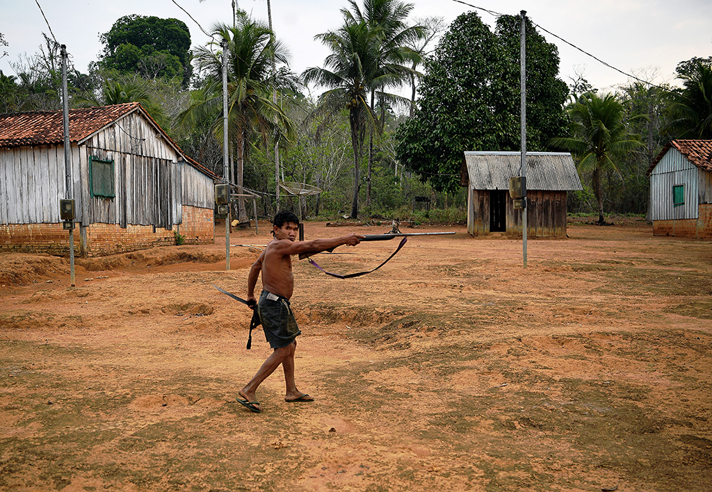 In this file a member of Uru Eu Wau Wau tribe holds up a rifle in the tribe's reserve in the Amazon, south of Porto Velho, Brazil.