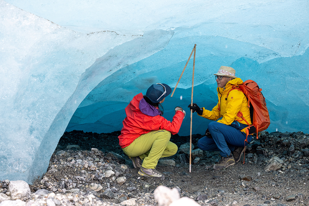 Glaciologists Andrea Fischer (right) and Violeta Lauria from the Austrian Academy of Sciences measure the height under a part of the ice shelf of the Jamtal Glacier (Jamtalferner) near Galtuer, Tyrol, Austria. 