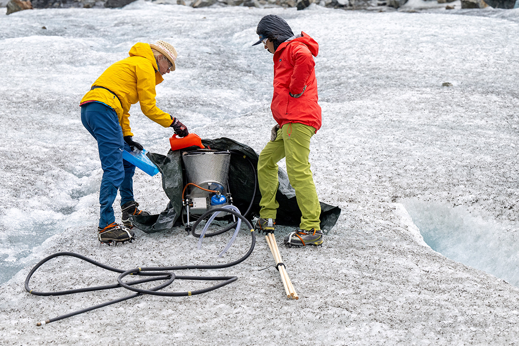 Glaciologists Andrea Fischer and Violeta Lauria from the Austrian Academy of Sciences collect samples at the Jamtal Glacier (Jamtalferner) near Galtuer, Tyrol, Austria. 