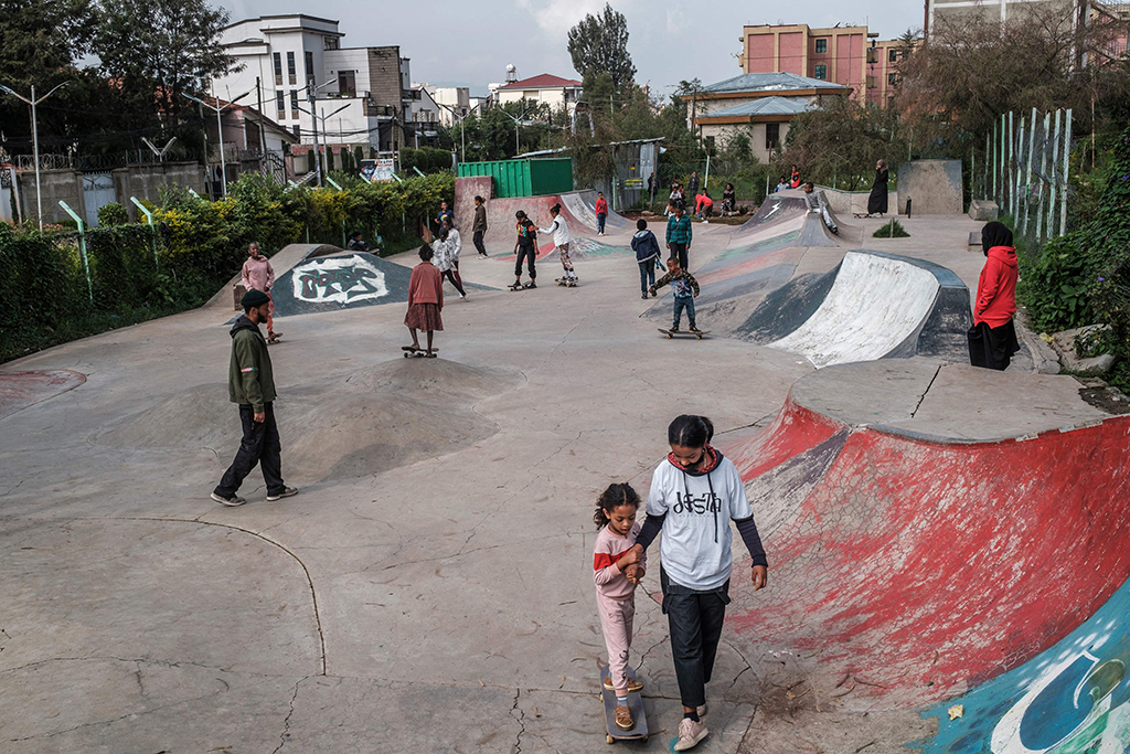 A trainer teaches a young girl how to skate in a skate park as part of a weekly training of the group Ethiopian Girls Skate, in Addis Ababa.