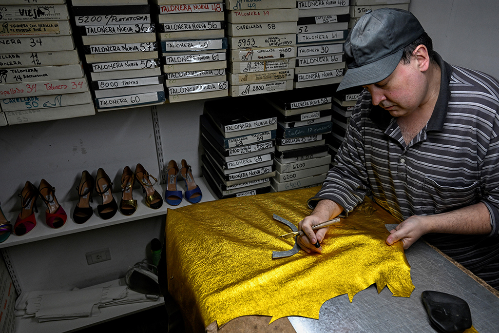 Luis Beron, shoemaker specialized in making shoes for dancing tango, works in his workshop at the 