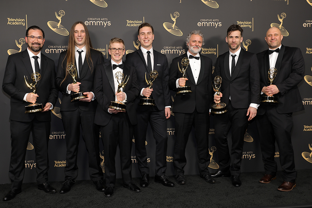 Team from 'The Beatles: Get Back: Part 3' pose with the award for Outstanding Sound Editing for a Nonfiction or Reality Program.