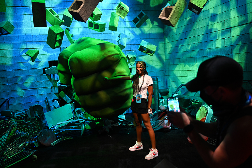 An attendee takes pictures with an Hulk fist during the Walt Disney D23 Expo.